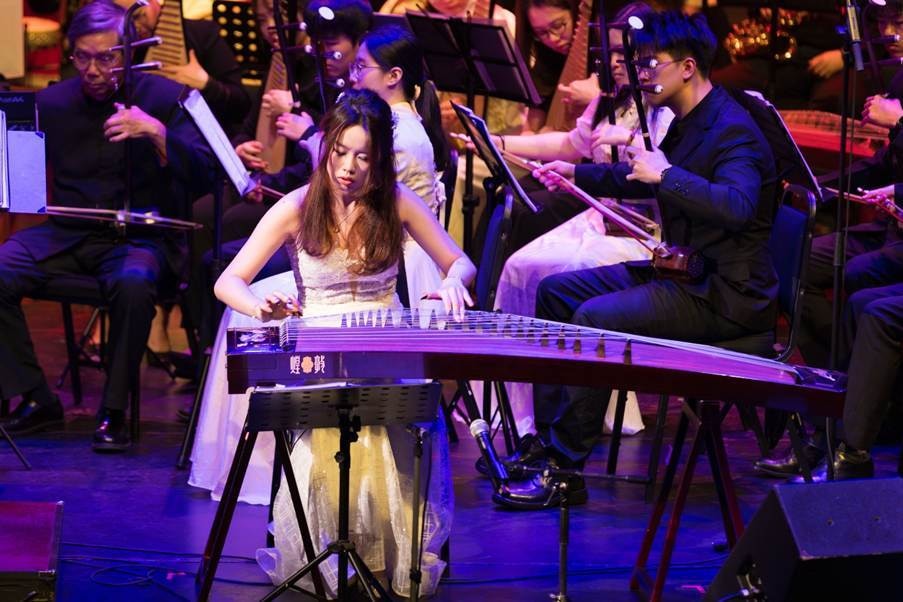 A YCMA guzheng soloist performing with an ensemble